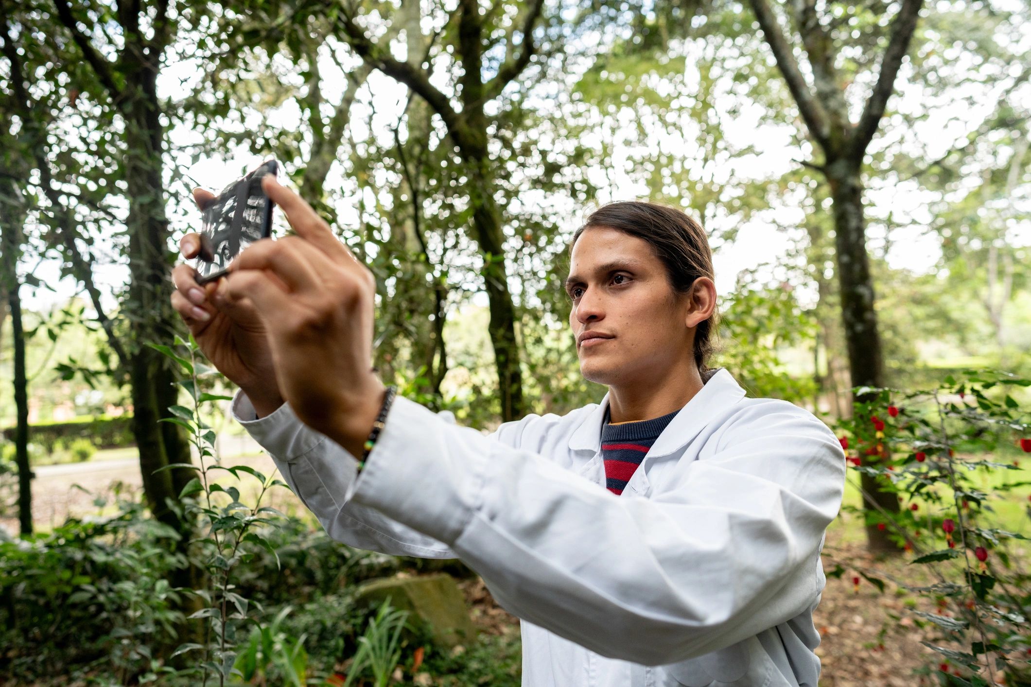 Biologist in a nature park using a phone